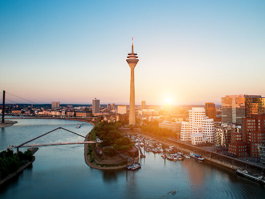 City panorama Düsseldorf with the river Rhine at sunset