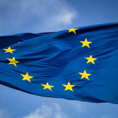 Flag of the European Union waving in blue sky